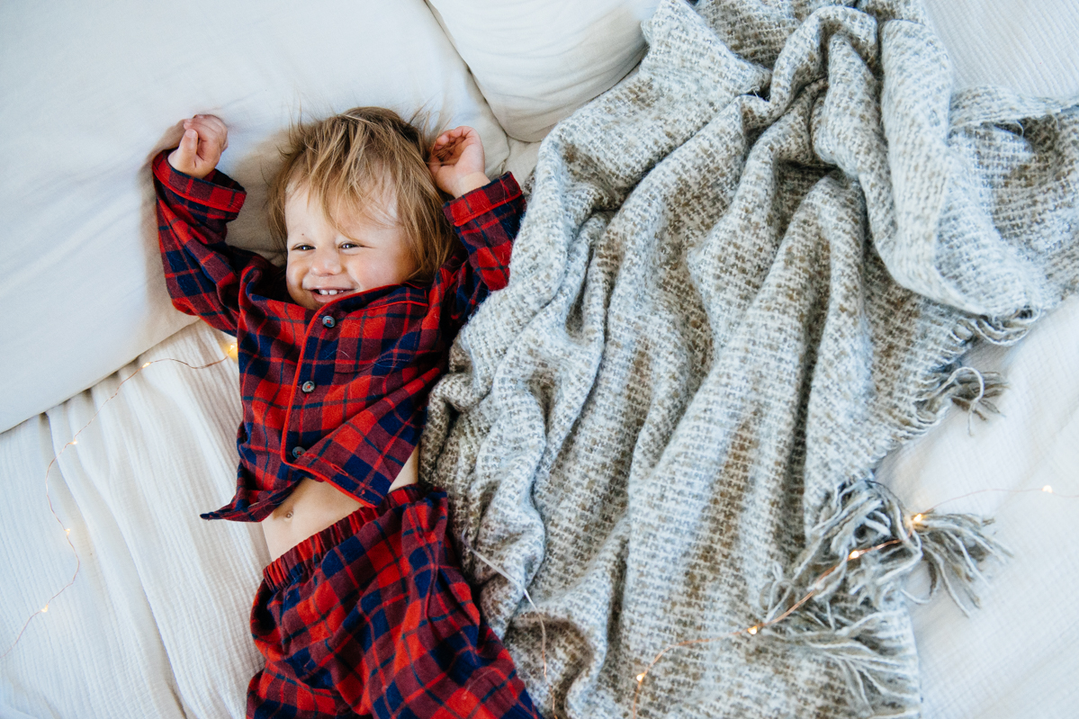 Kimberly Lapides of eatsleepwear sharing her favorite kids and toddler pajamas featuring 1212, clover baby & kids, target, gap kids, h&m kids. Showing toddler and dog in matching plaid pajamas from janie and jack.
