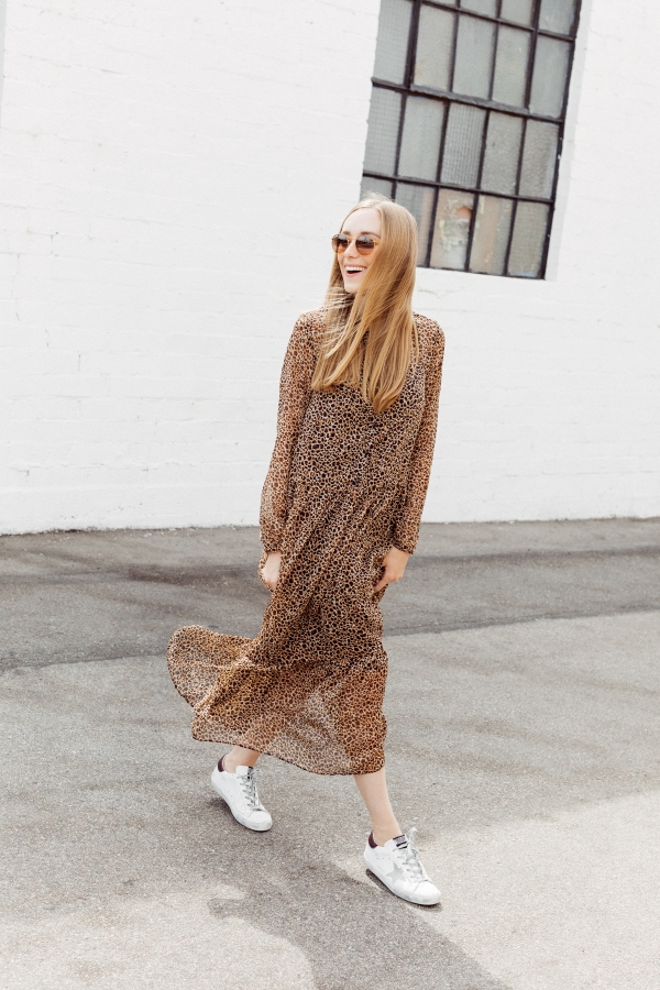 Kimberly Lapides of eatsleepwear wearing a long leopard maxi dress from h&m and golden goose sneakers with ray-ban sunglasses.