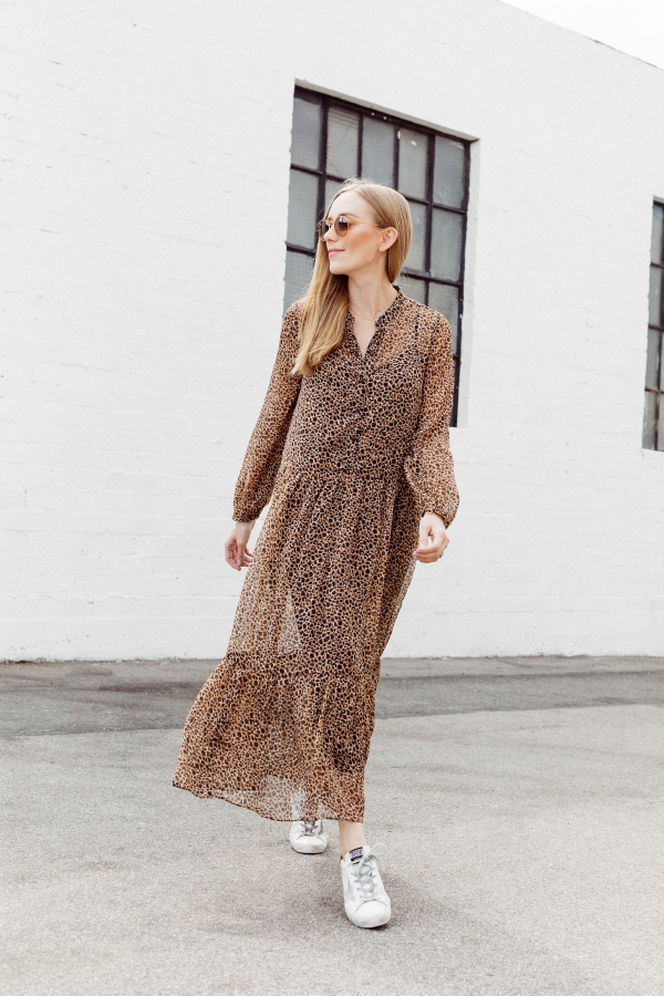 Kimberly Lapides of eatsleepwear wearing a long leopard maxi dress from h&m and golden goose sneakers with ray-ban sunglasses.