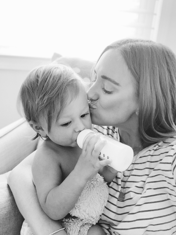 photo of mother weaning from breastfeeding with a bottle of formula