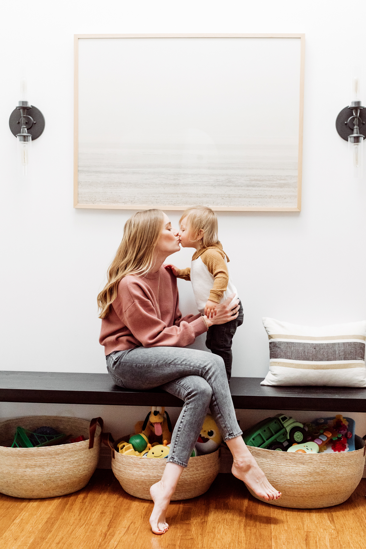 Kids toys organized in Citizenry baskets under an entryway bench by Kimberly Lapides of eatsleepwear