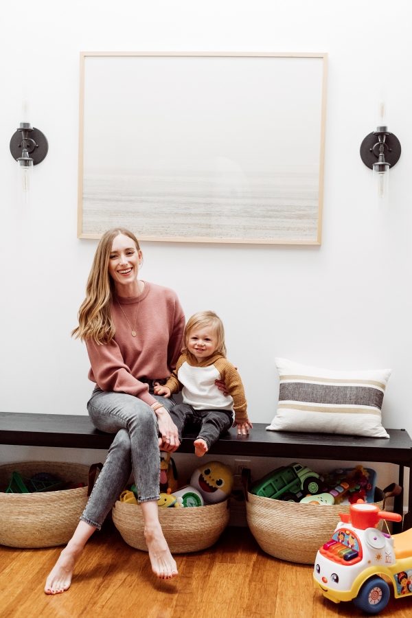 Kids toys organized in Citizenry baskets under an entryway bench by Kimberly Lapides of eatsleepwear
