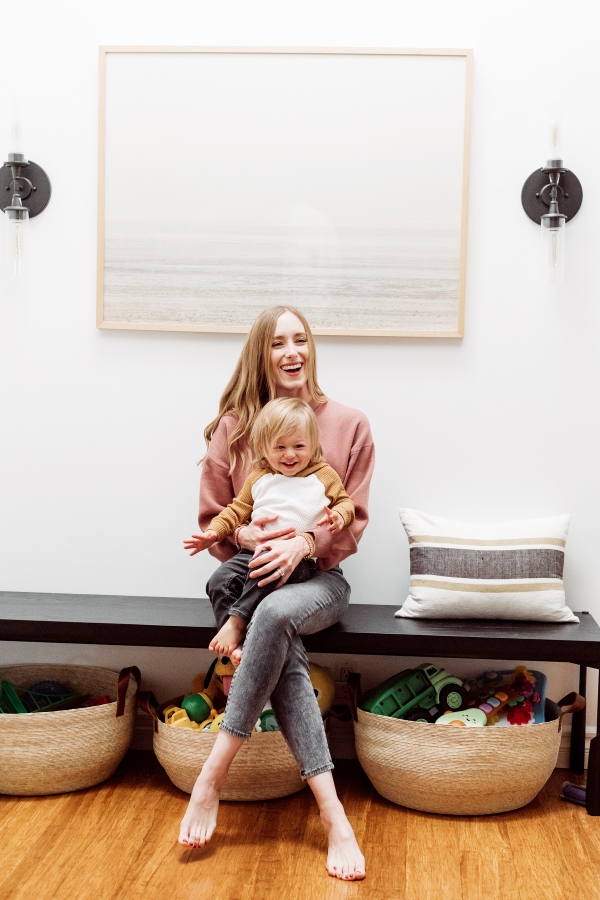 Mother and son laughing with Kids toys organized in baskets by Kimberly Lapides of eatsleepwear