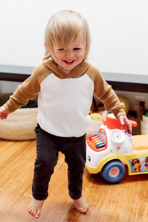 Toddler laughing with toys
