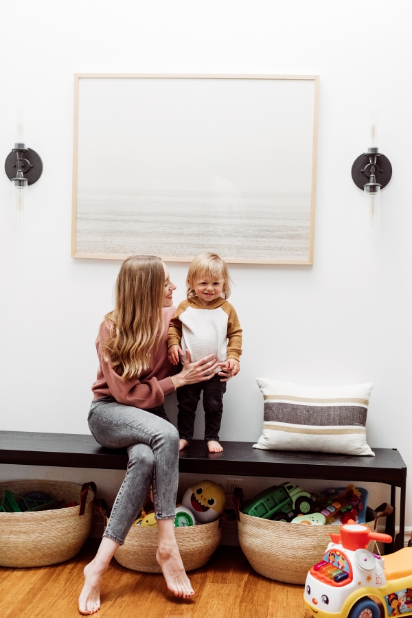 Mother and son sharing kids toy storage ideas using chic woven baskets by Kimberly Lapides of eatsleepwear