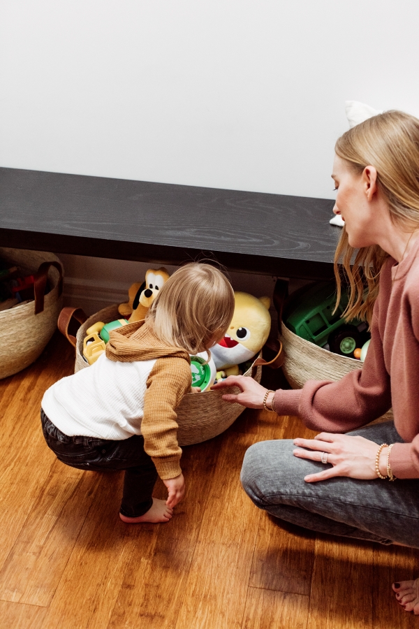 Mother and son playing with toddler toys organized in baskets by Kimberly Lapides of eatsleepwear