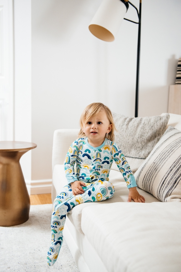 toddler on couch wearing Clover Baby & Kids pajamas celebrating Rainbow Baby, IVF, and Infertility