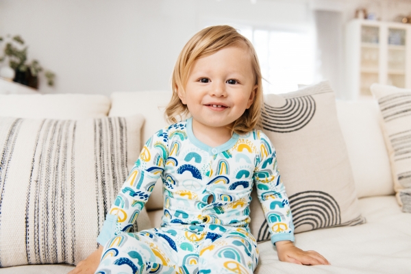 toddler on couch wearing Clover Baby & Kids pajamas celebrating Rainbow Baby, IVF, and Infertility