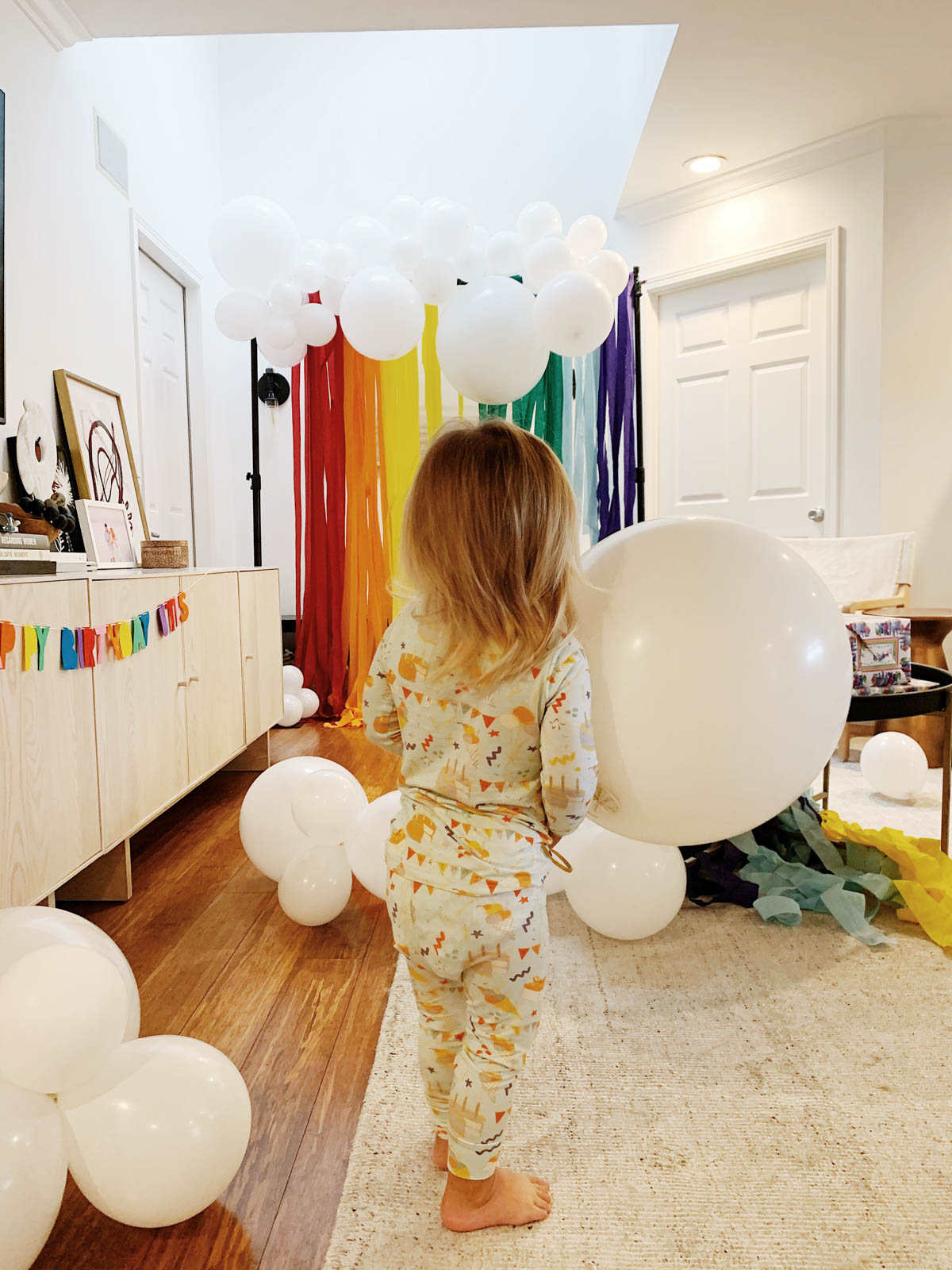 Otis playing with balloons at trolls themed birthday