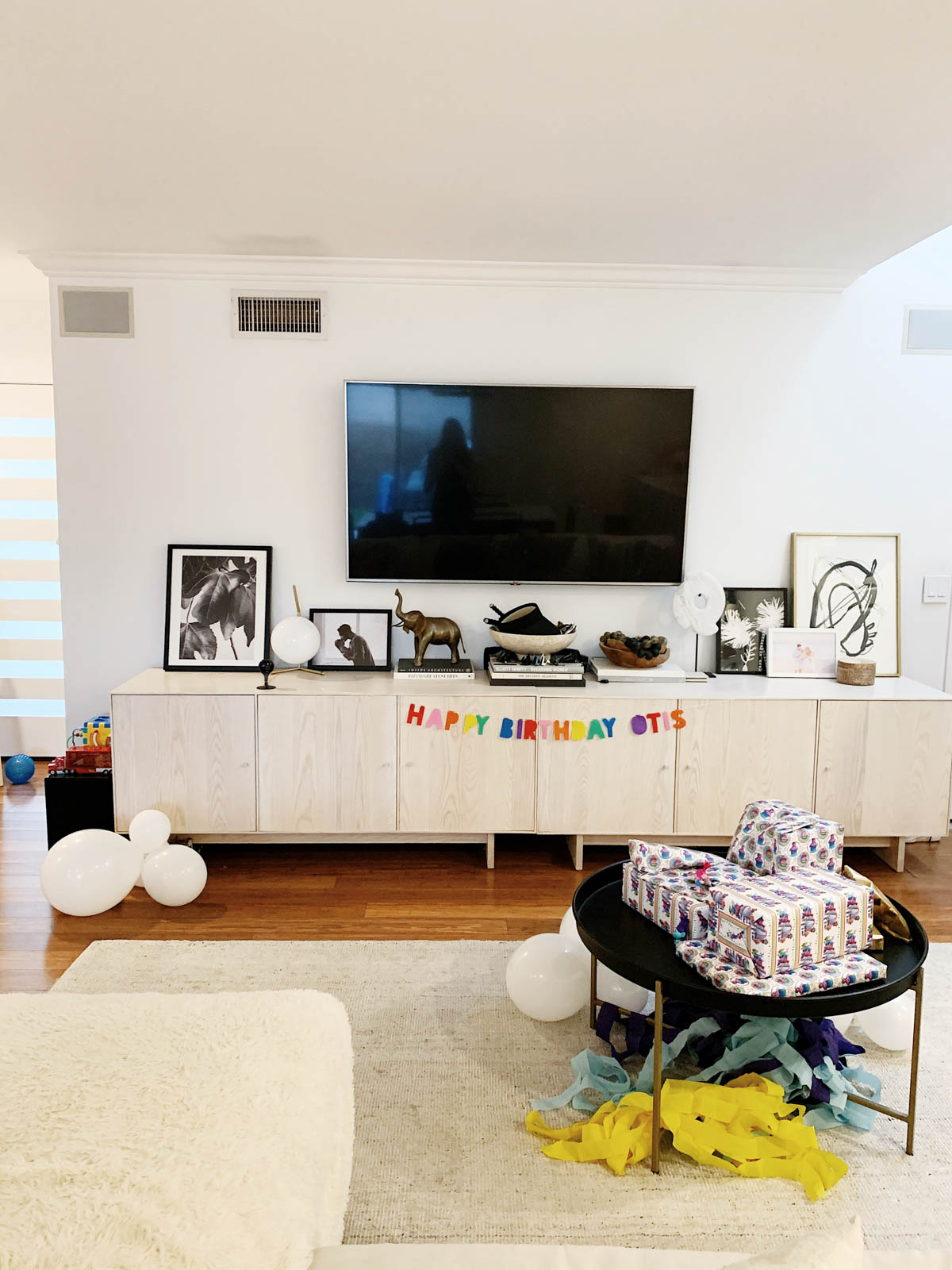 Trolls themed birthday decor showing a custom birthday banner and custom trolls wrapping paper