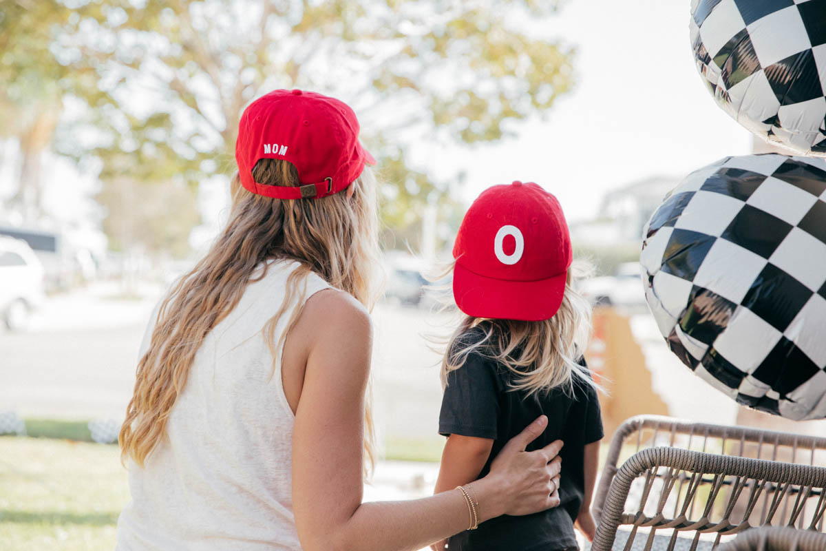 Mother and Son wearing matching custom embroidered red hats at Disney Pixar Cars themed birthday