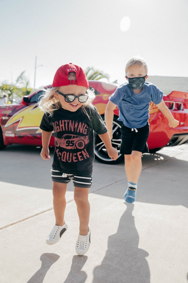 Toddlers dancing in front of Lightning McQueen Impersonator at Disney Pixar Cars themed birthday