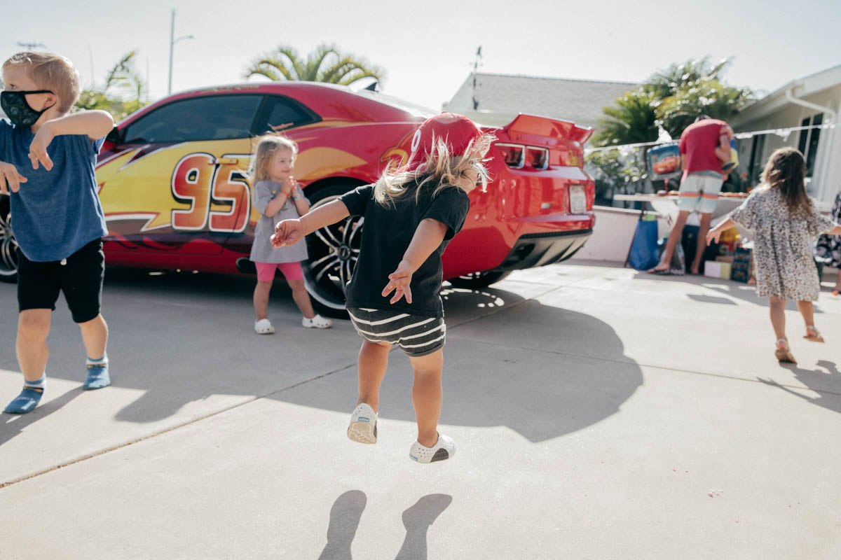 Toddlers dancing in front of Lightning McQueen Impersonator at Disney Pixar Cars themed birthday