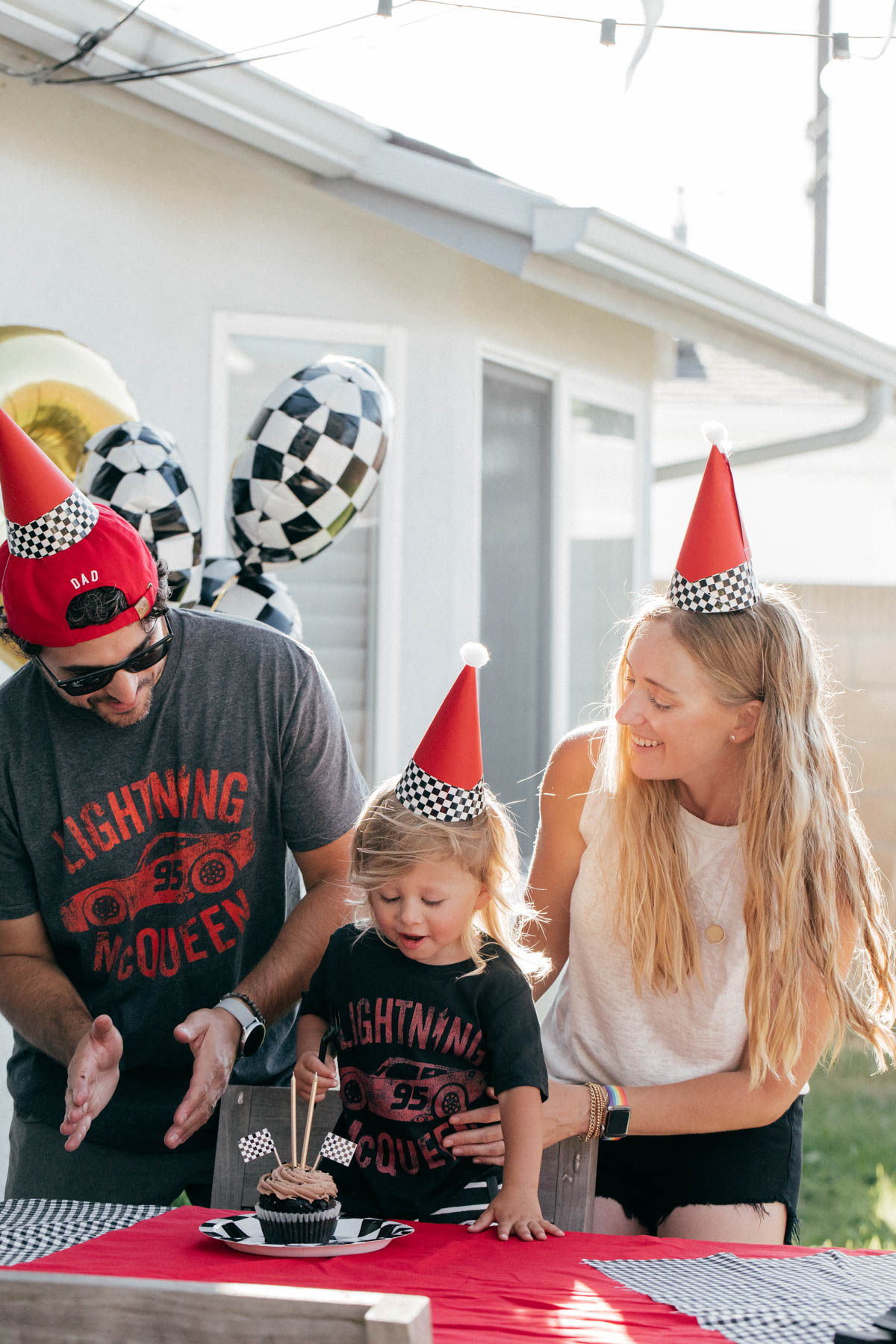 Singing Happy Birthday with Cupcake and race car theme decorations at Disney Pixar Cars themed birthday