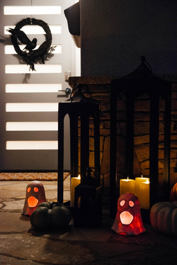Fall & Halloween Decor For Patio & Yard with Lanterns, faux pumpkins, crow wreath and LED ghosts lit up at night
