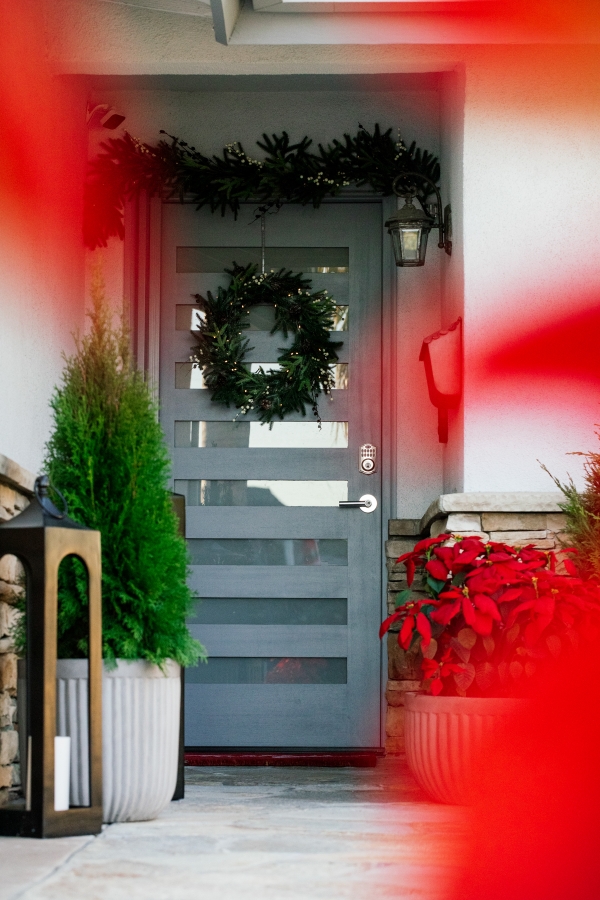 Outside Holiday Decor of wreath, garland and planted poinsettias 