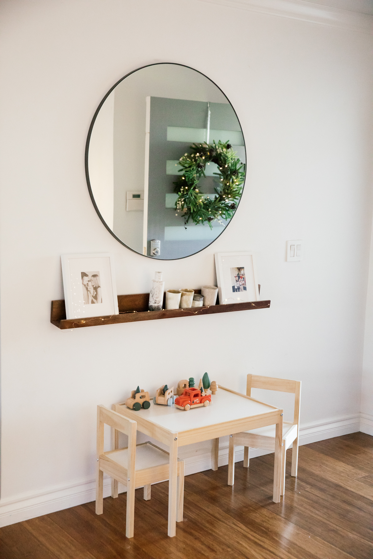 Indoor Holiday decor of kids table, wreath and kids Christmas truck toys