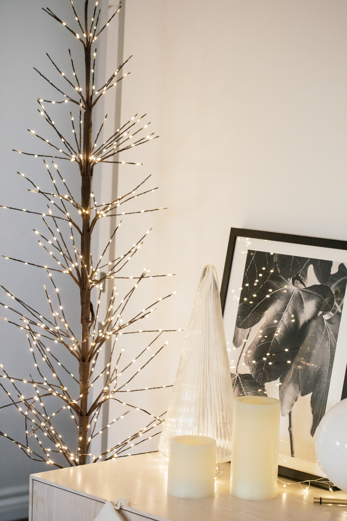 Indoor Holiday decor of twinkle lights tree, twinkle lights, clear glass Christmas tree cloche
